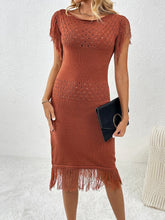 Women's openwork knit dress with a boat neckline and fringe detailing.
