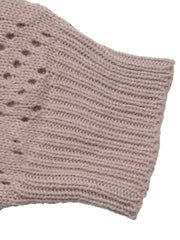 Close up of a pink openwork sleeve with ribbed cuff and dotted knit pattern