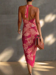 Back view of the rose red floral halter midi dress with open back and tied halter straps