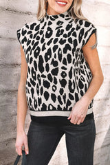 Front view of the black and cream leopard print high neck sweater with cap sleeves, outdoors.