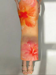 Lower view of tangerine tropical flower print bodycon tube dress showing hibiscus flowers and hem