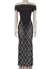 Front view of black off shoulder maxi dress with sheer rhinestone skirt on a mannequin