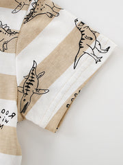 Close-up of the short sleeve hem and dinosaur print on a tan and white striped children's T-shirt