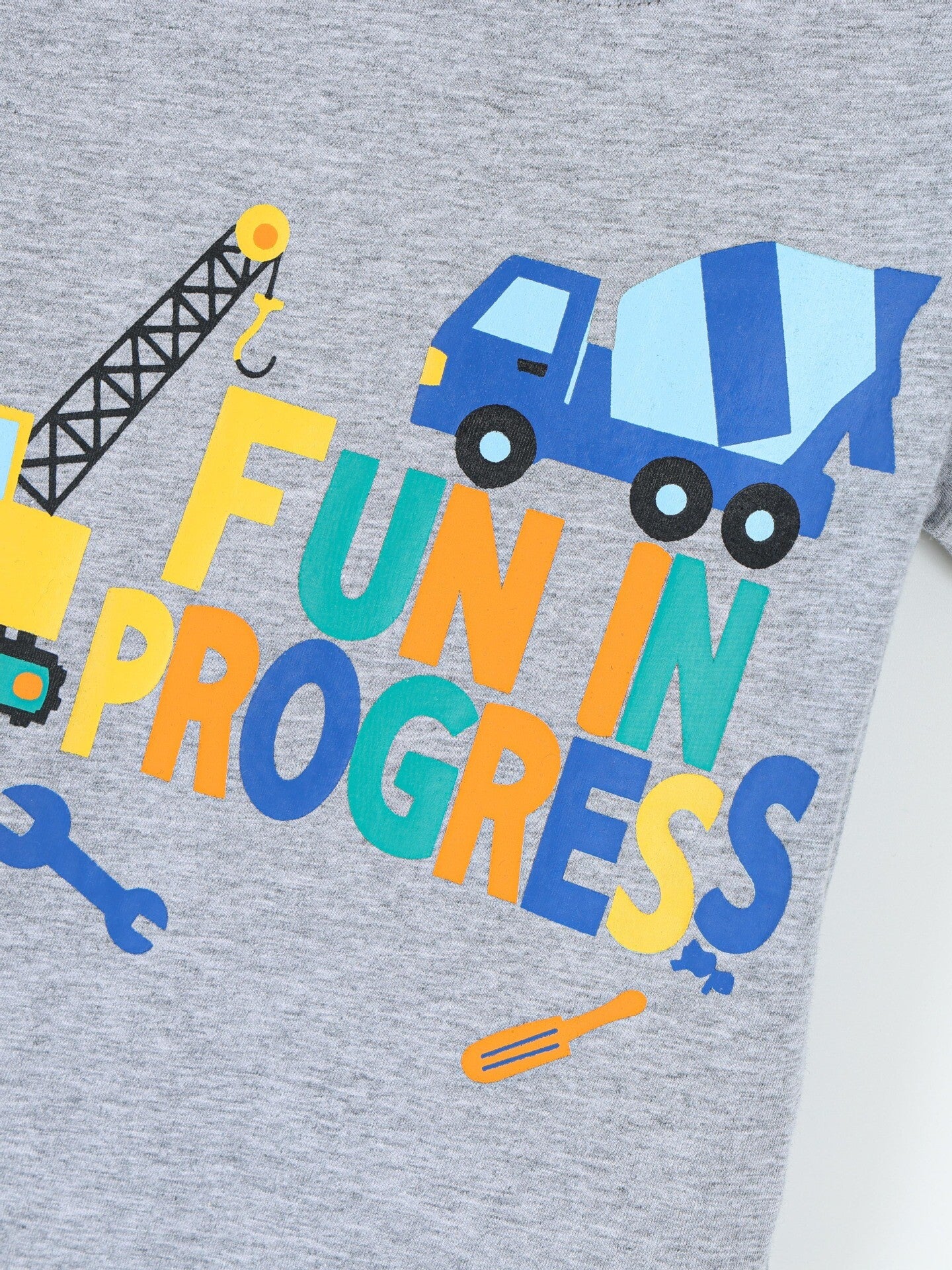 Close-up of construction truck and colorful lettering print on gray children's t-shirt