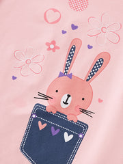 Close-up of bunny in denim pocket with hearts and flowers on dusty pink tee