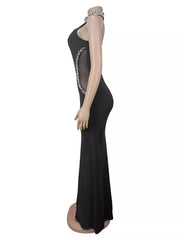 Side view of black sleeveless maxi dress on mannequin showing sheer waist panel