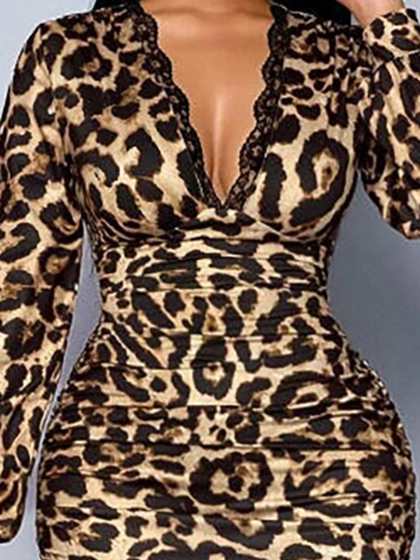 Close view of leopard print bodice showing lace trimmed V neck and ruched fabric