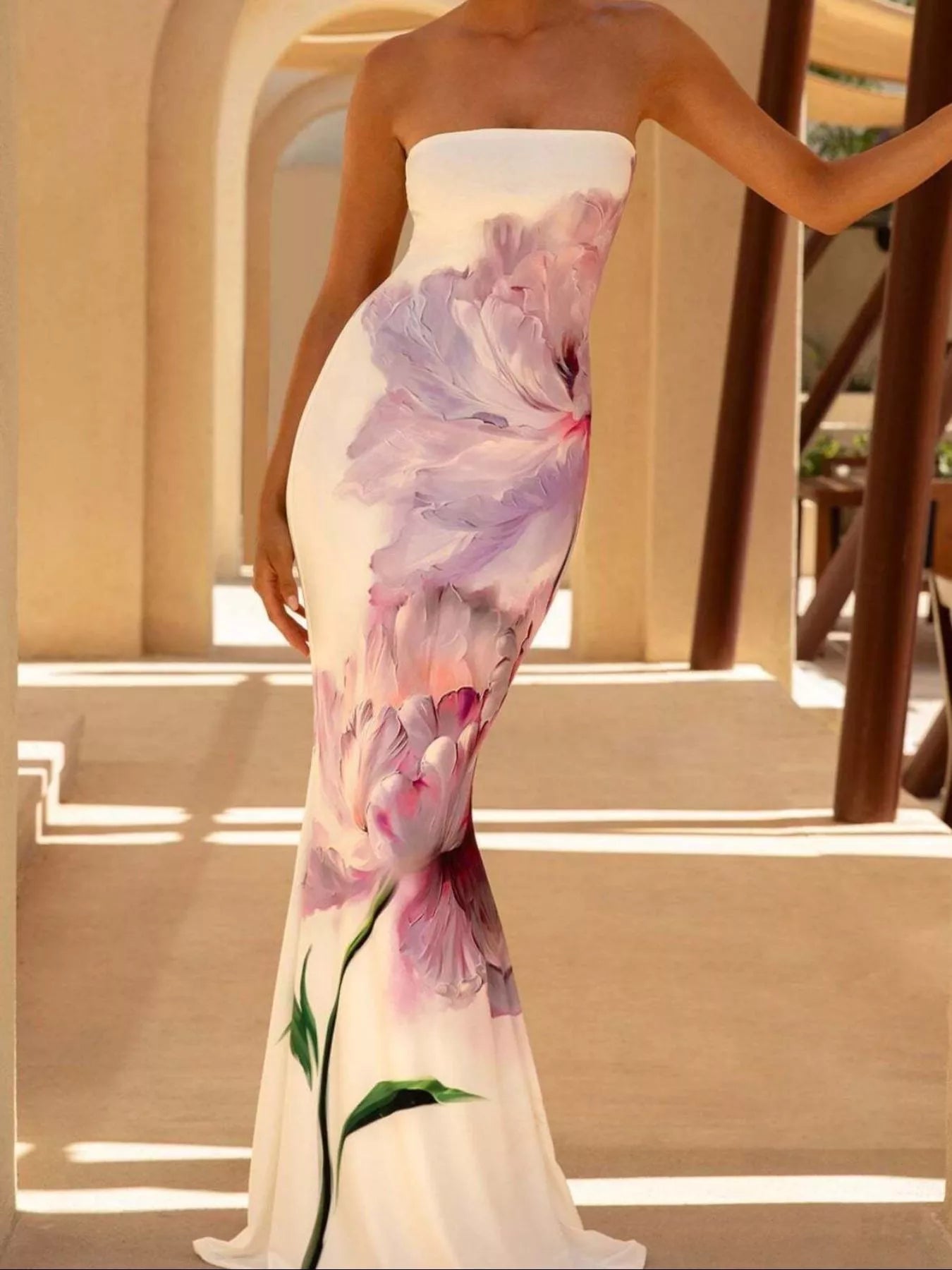 Model wearing strapless white and purple floral tube maxi dress, side view outdoors