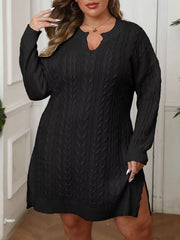 Front view of black cable knit sweater dress with long sleeves and side slit