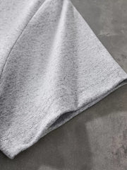 Close up of the light gray short sleeve hem and double stitching on the T-shirt