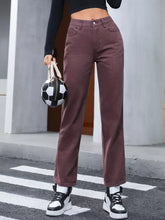 Women's dark brown straight-leg jeans with buttons and pockets.