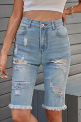 Women's long Bermuda shorts with distressed detailing and raw hems.