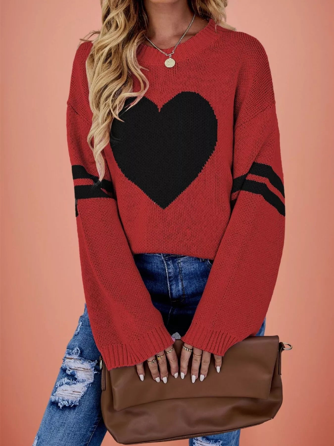 Front view of a red dropped shoulder sweater with a large black heart