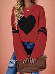 Front view of a red dropped shoulder sweater with a large black heart