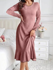 Dusty pink ribbed knit bodycon dress with ruffle hem, front view with hand on hip