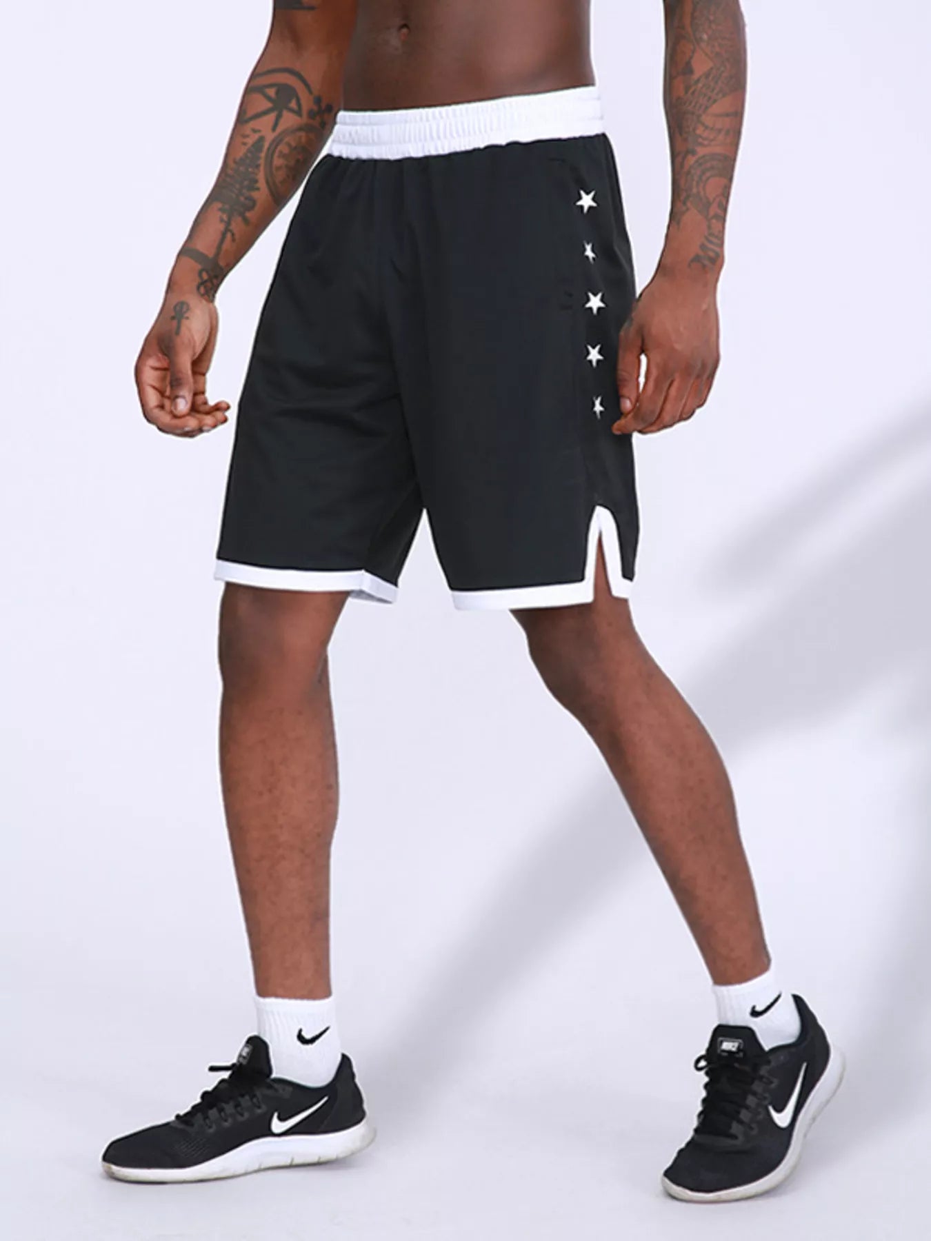 Men's black active shorts with star print and lightweight, breathable fabric.