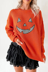 Front view of an orange sweater with a black and white checkered pumpkin face