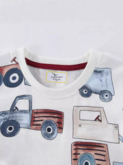 Close up of white children's t-shirt round neckline with red inner trim and truck print