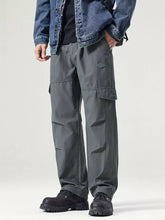 Men's dark gray wide-leg cargo pants with a drawstring waist and pockets.