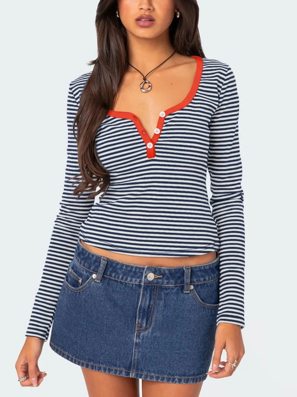 Navy and white striped long sleeve t shirt with orange red trim and white buttons worn on model front view