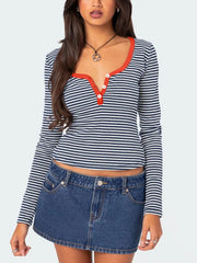 Navy and white striped long sleeve t shirt with orange red trim and white buttons worn on model front view