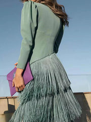 Back view of a gum leaf green fringed maxi dress with puff sleeves and layered fringe