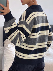 On-model back view of the navy, gray, and cream striped long sleeve sweater