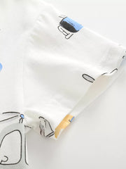Close-up of the white cotton sleeve and hem stitching with a partial vehicle print