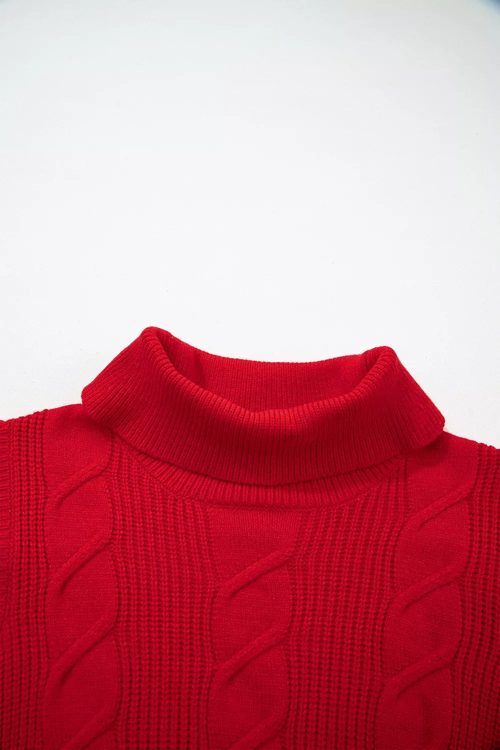 Close-up of the red cable knit turtleneck sweater front neckline