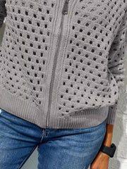 Close up of the light gray crochet cardigan lower zip and ribbed hem