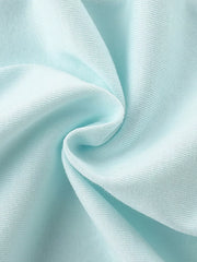 Close-up of soft folded mint blue knit fabric texture of children's short sleeve t-shirt