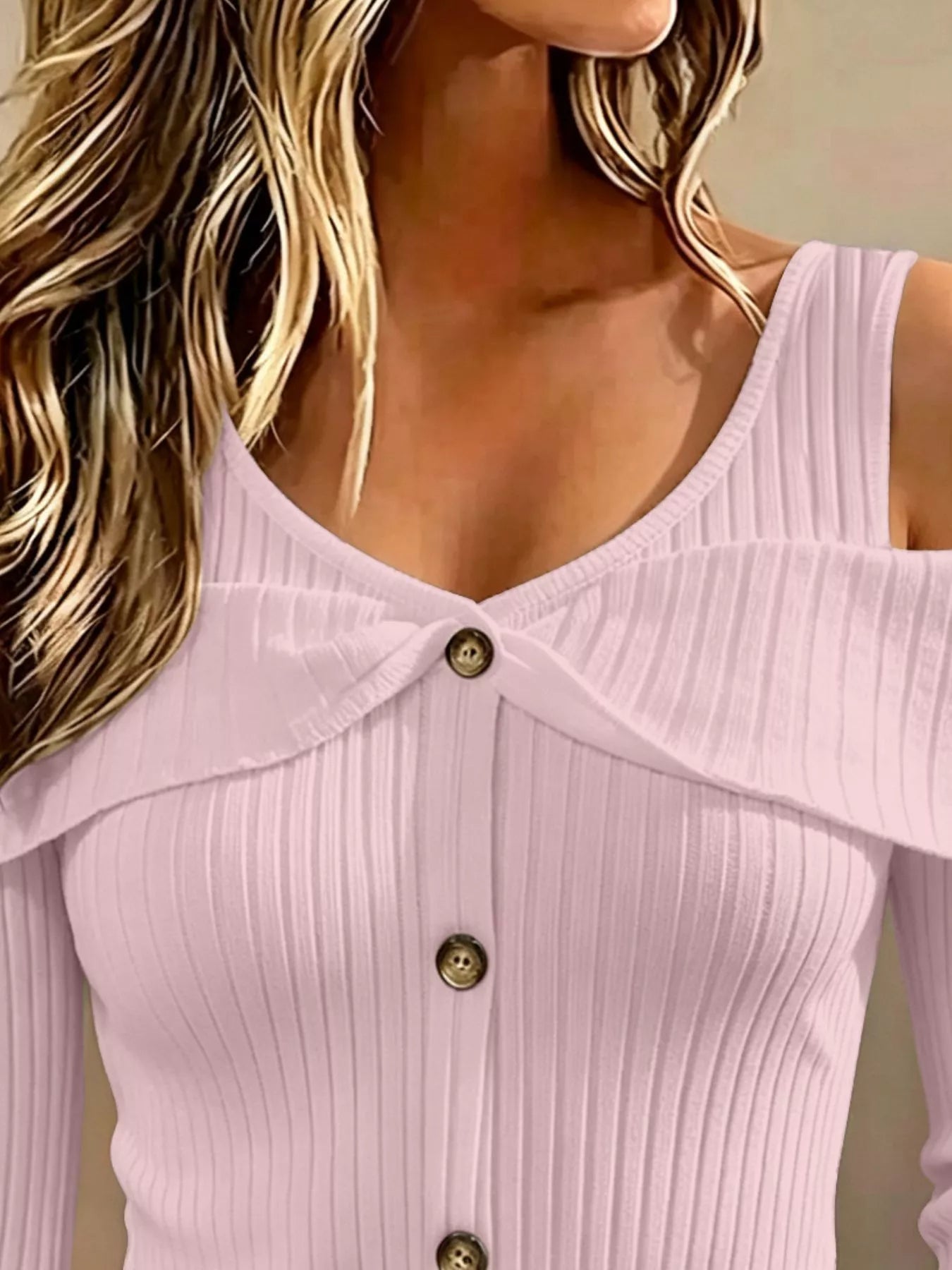 Close up of light pink cold shoulder ribbed knit top neckline with foldover collar and button