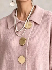 Close up of the pale pink cardigan collar and large gold buttons