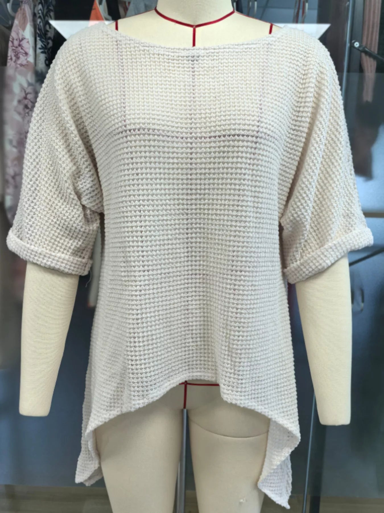 Front view of a white waffle knit cover-up with wide sleeves on a mannequin