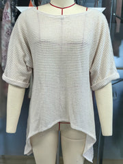 Front view of a white waffle knit cover-up with wide sleeves on a mannequin