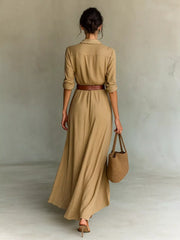 Back view of a camel long sleeve shirt maxi dress with a brown belt and flowing skirt