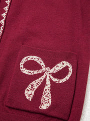 Close view of the burgundy bow pocket with cream lace bow detail