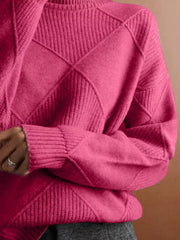 Close torso view of the cerise turtleneck sweater with diamond knit panels