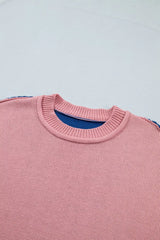 Close up of the pink sweater front neckline with ribbed trim and blue lining