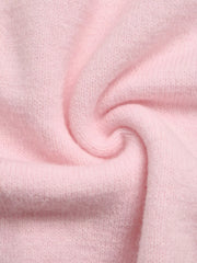 Close-up of soft pink knit fabric with a gentle twist showing its fuzzy texture