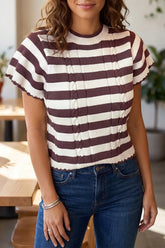 Front view of brown and cream striped ribbed knit sweater with cable detail and short sleeves worn with jeans.
