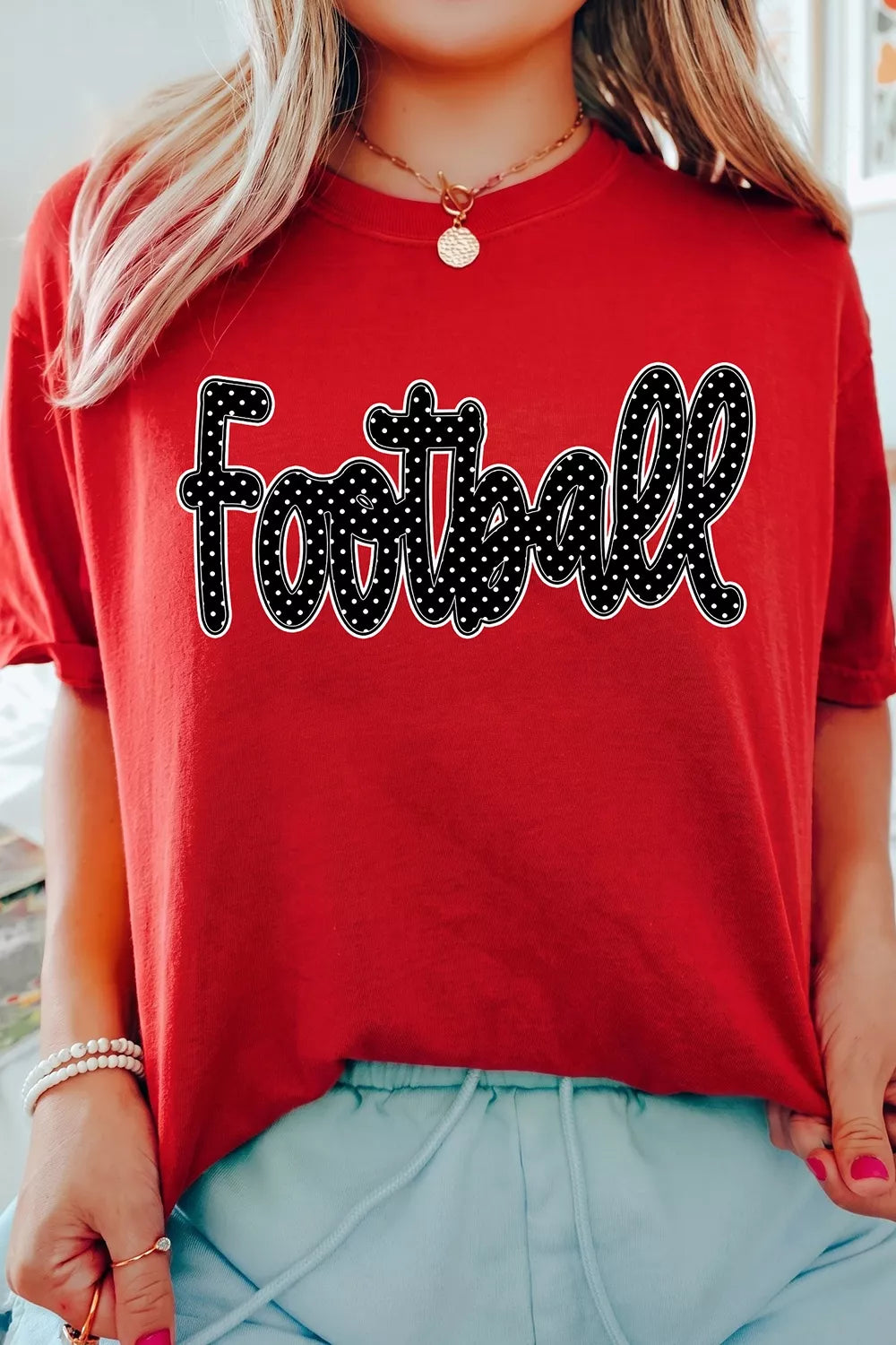 Close front view of deep red game day t shirt with polka dot Football lettering
