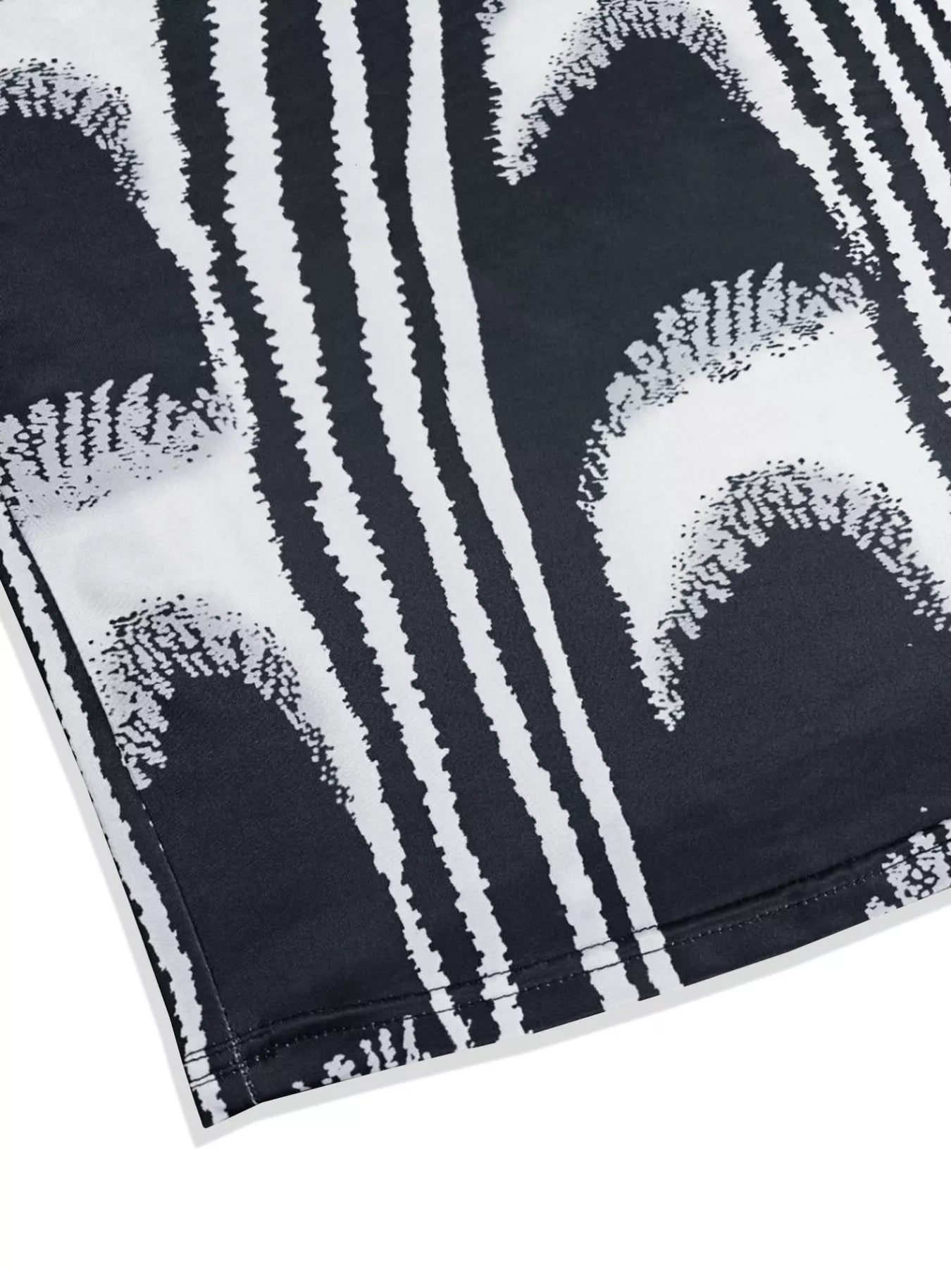 Close view of the hem and abstract print on a black and white sleeveless bodycon maxi dress