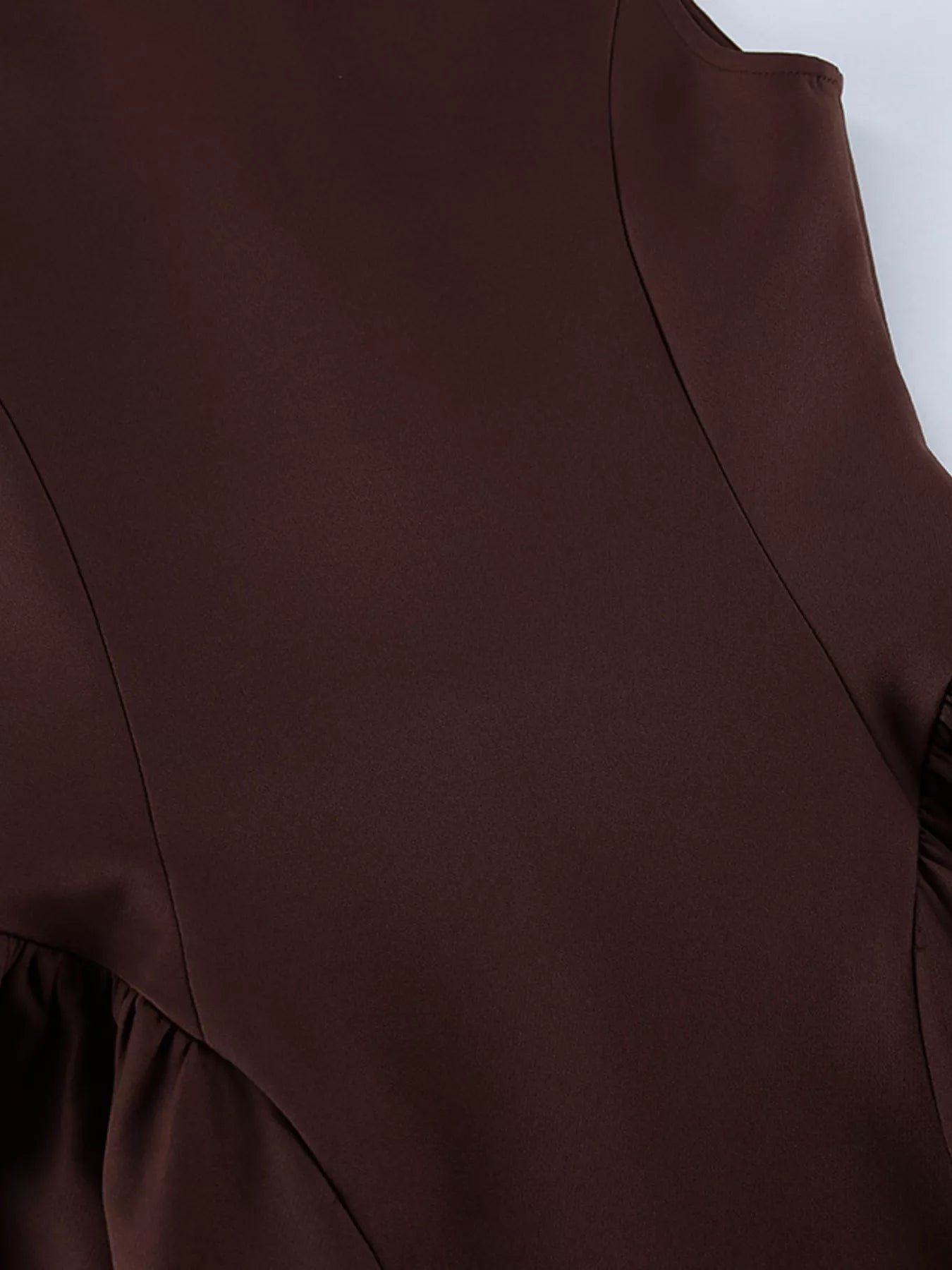 Brown button down mini dress detail showing bodice seams and gathered skirt sides