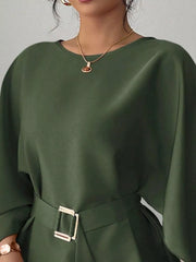 Close view of army green round neck blouse showing neckline and gold buckle belt