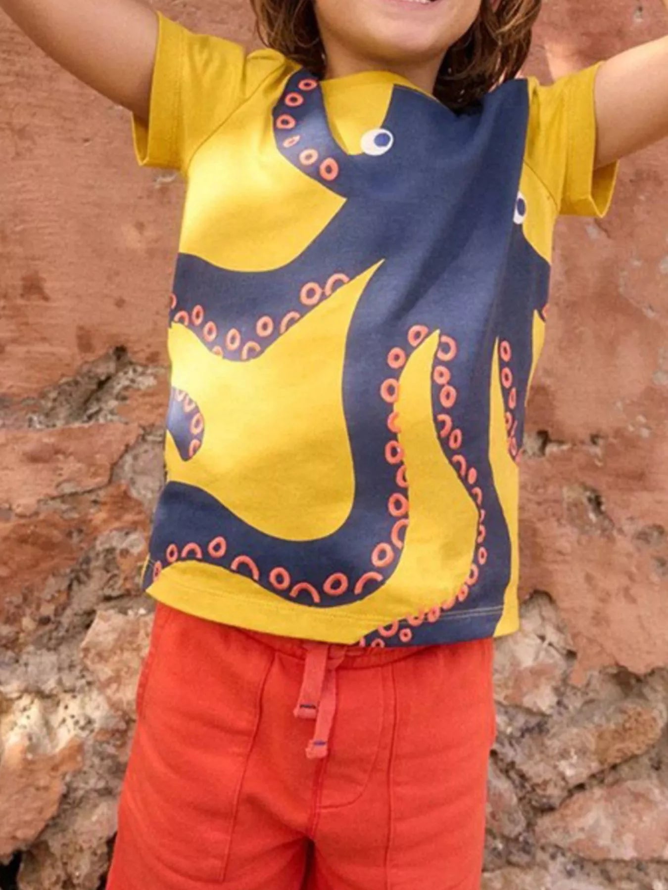 Children's gold short-sleeve T-shirt featuring an octopus graphic design.