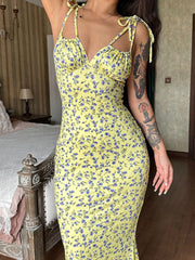 Close up of yellow floral print bodycon maxi dress bodice with tie straps and ruched neckline