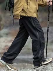 Men's black tactical cargo pants with multiple pockets and a drawstring waist.
