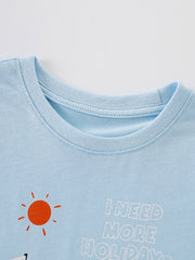 Close view of the round neckline and orange sun detail on the light blue children's tee