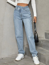 Women's straight-leg jeans with an asymmetrical waist, buttons, and pockets.